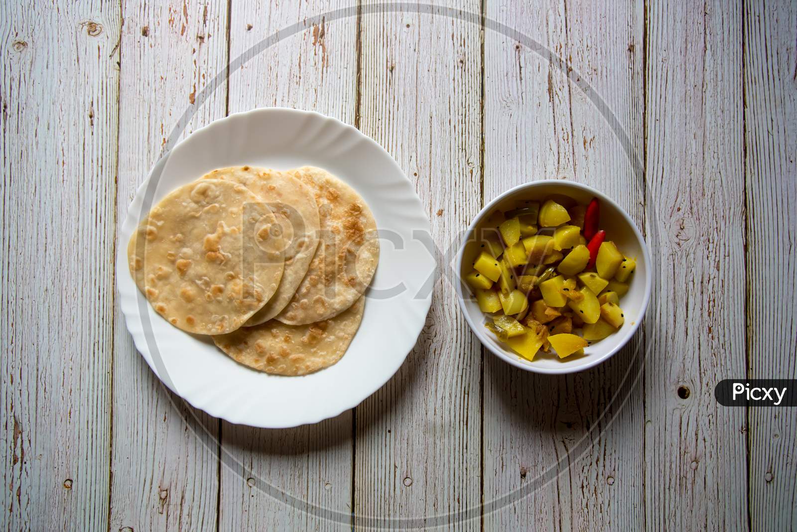 Top view of popular Indian breakfast paratha with fried potatoes