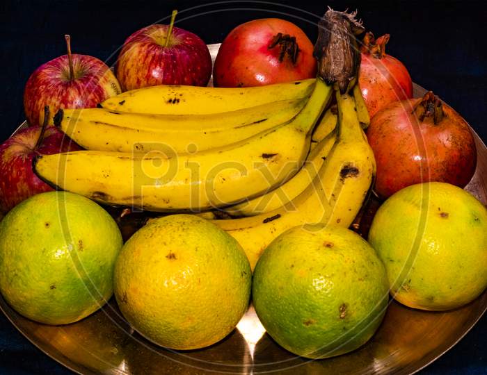 Fresh ripe mixed fruits served on brass plate
