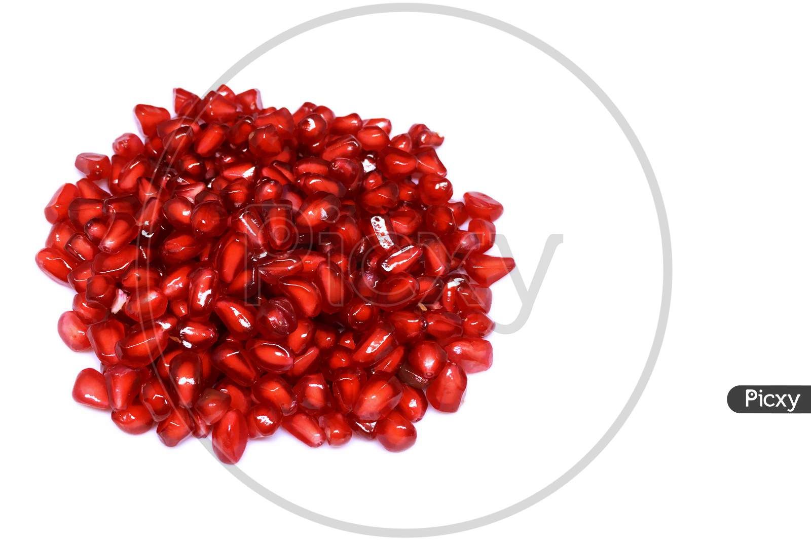 Red fresh pomegranate seeds isolated on white background