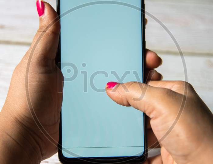 Close up of female hands holding a smartphone.