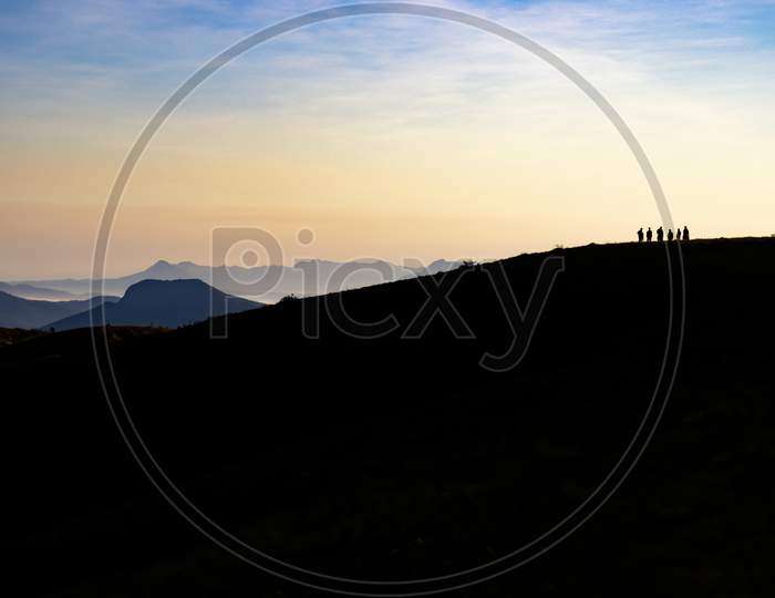 Silhouette of landscape at sunset, vibrant sky, minimalistic