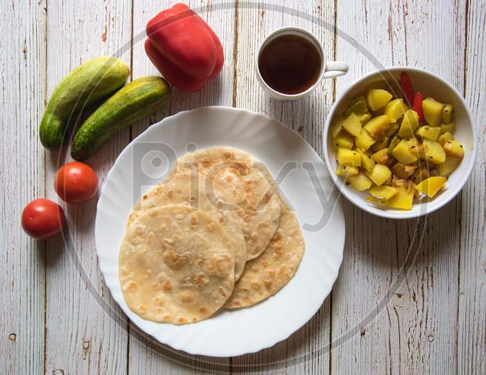 Whole breakfast meal Indian bread along with cooked potatoes