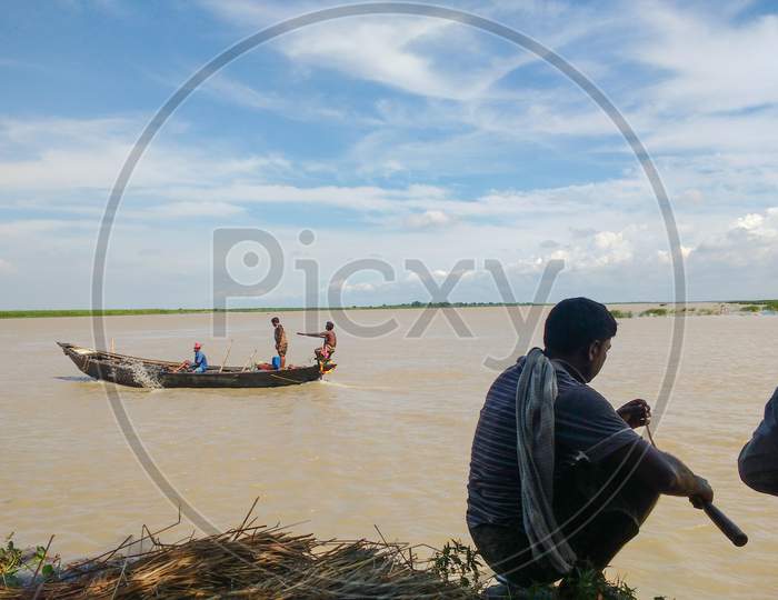 Fisherman On River Bank Stock Image