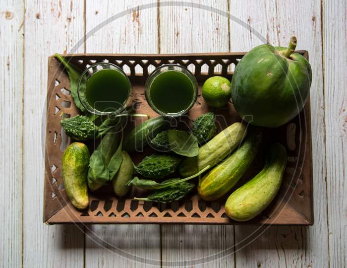 Fresh green vegetables arranged in a wooden tray