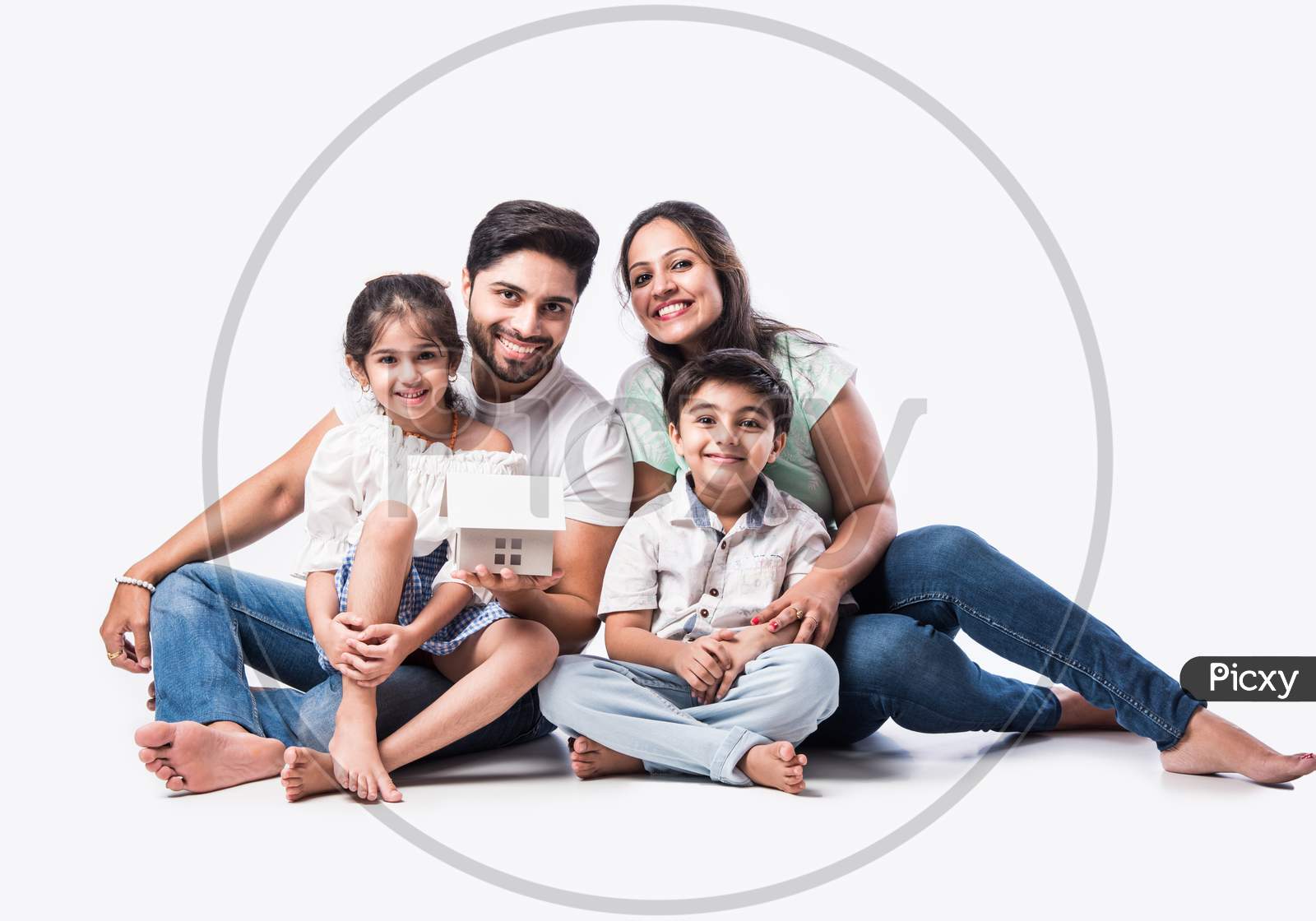 Image Of Real Estate Concept Indian Happy And Young Family Of Four Holding 3d Paper Model Of Home Mx699212 Picxy