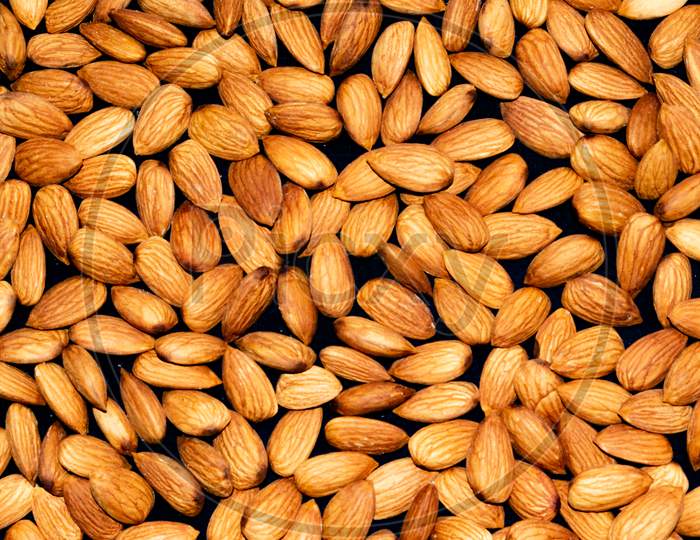 Pile of almond nuts background