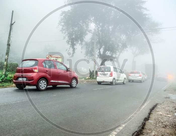 Lakkidi, Kerala / India - 09.31.2020 : Vehicles Moving From Both Sides In A Two Way Highway, Wet Road, With Zero Visibility Through The Misty Fog In A Hazy Moody Day In Lakkidi Wayanad, Western Ghats.