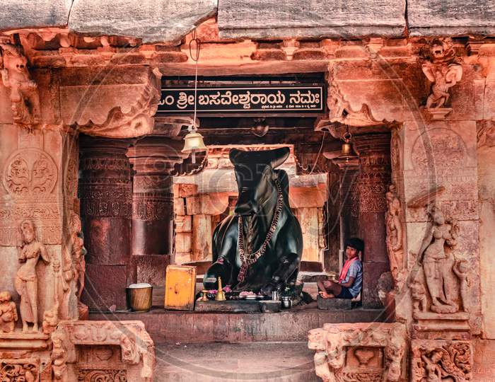 Ancient Temple With Bull Statue And Devotee