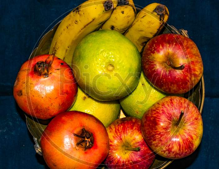 Fresh ripe colorful fruits on brass basket