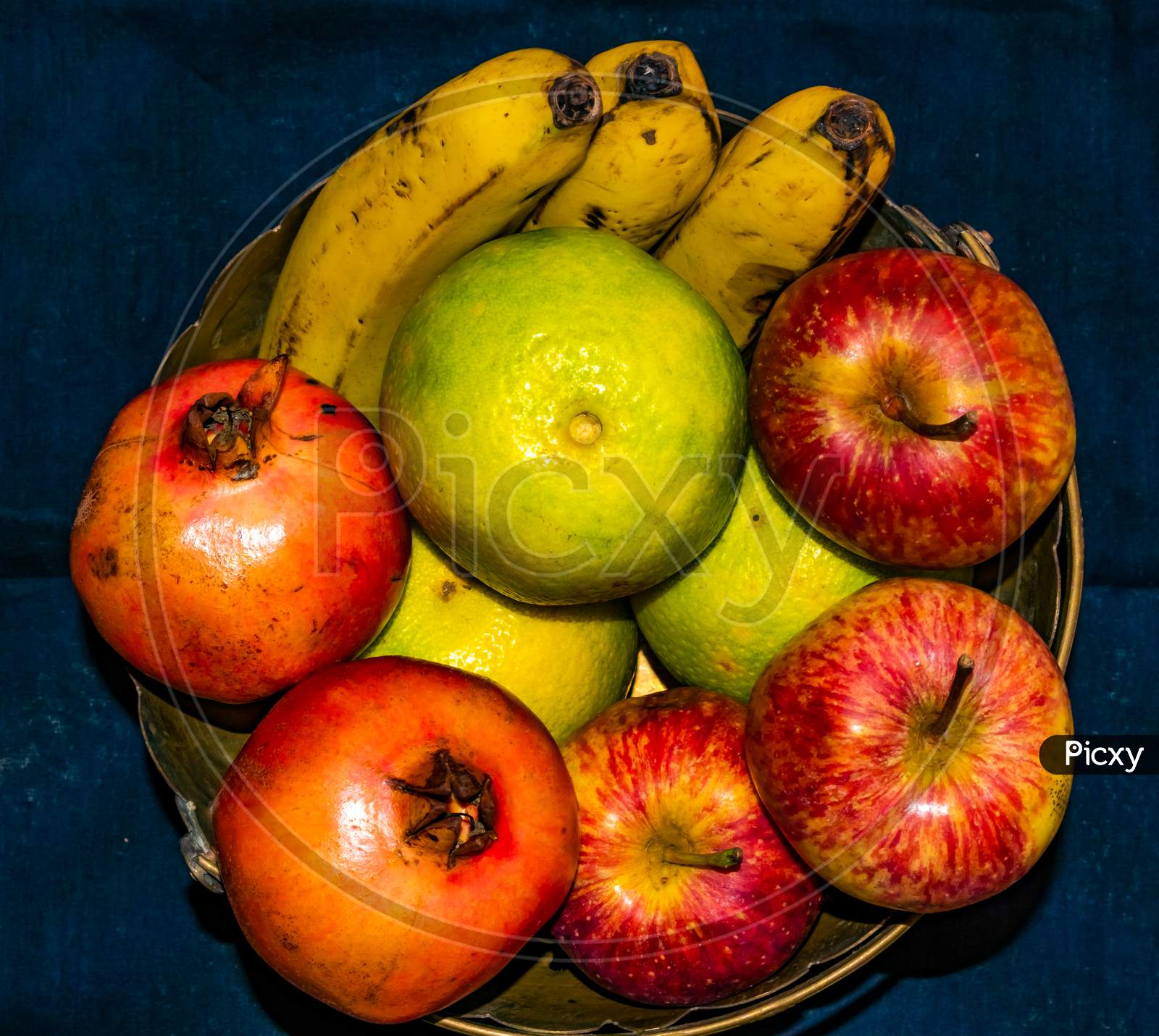 Fresh ripe colorful fruits on brass basket