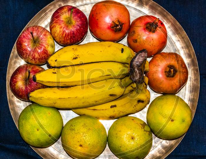 Variety of fresh ripe fruits on brass plate