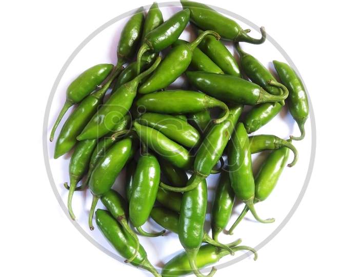 Pile of fresh green chili on white background