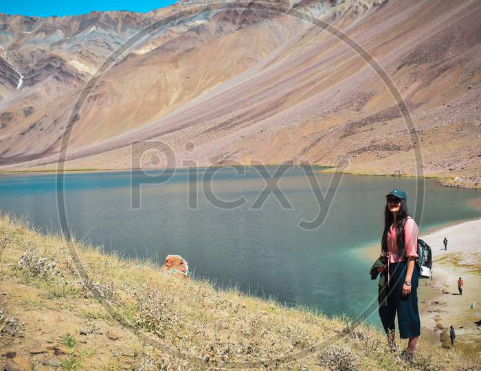 Trekking woman in Front of chandartaal lake or pangong lake of himachal located  in spiti, Himachal Pradesh.