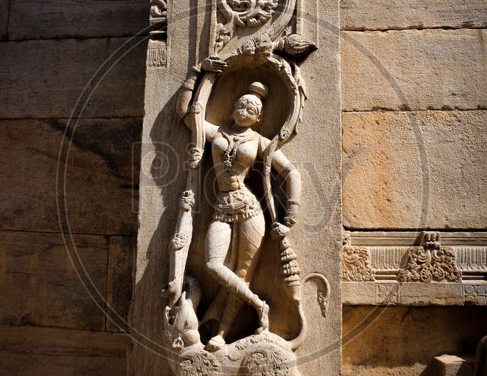 An Elegant Stone Carving of a Female Dancer on a Pillar of a Hindu Temple built over 6 century ago at Melukote near Mysuru in Karnataka/India.