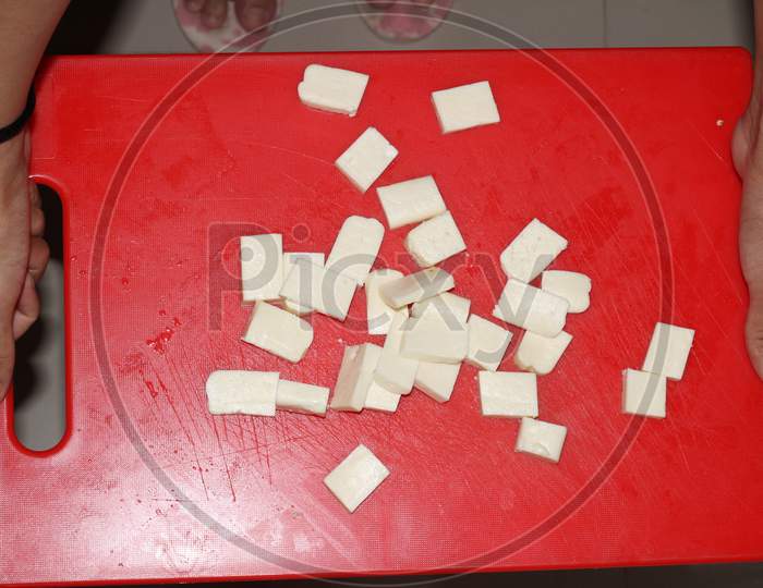 Image Of Closeup Of Paneer Cut Into Pieces On Cutting Board-of779398-picxy