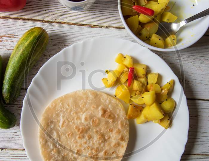 Popular breakfast food items paratha and cooked potatoes