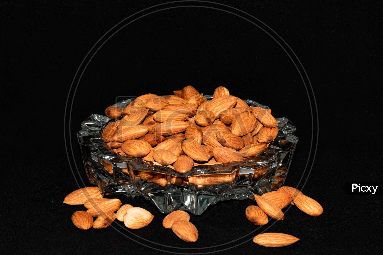 Fresh healthy almonds on a glass tray