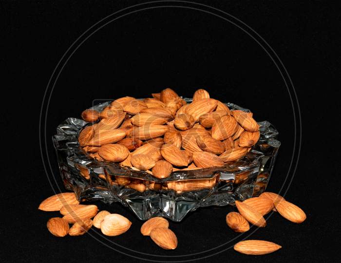 Fresh healthy almonds on a glass tray