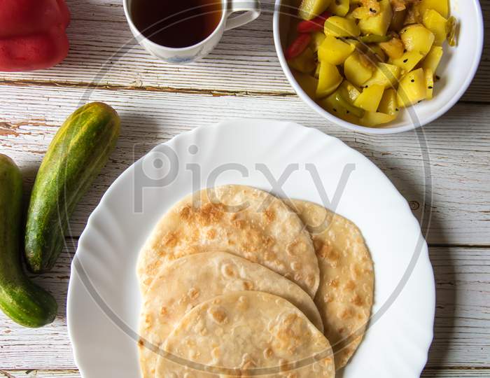 Vertical top view of popular Indian breakfast puri and sabzi