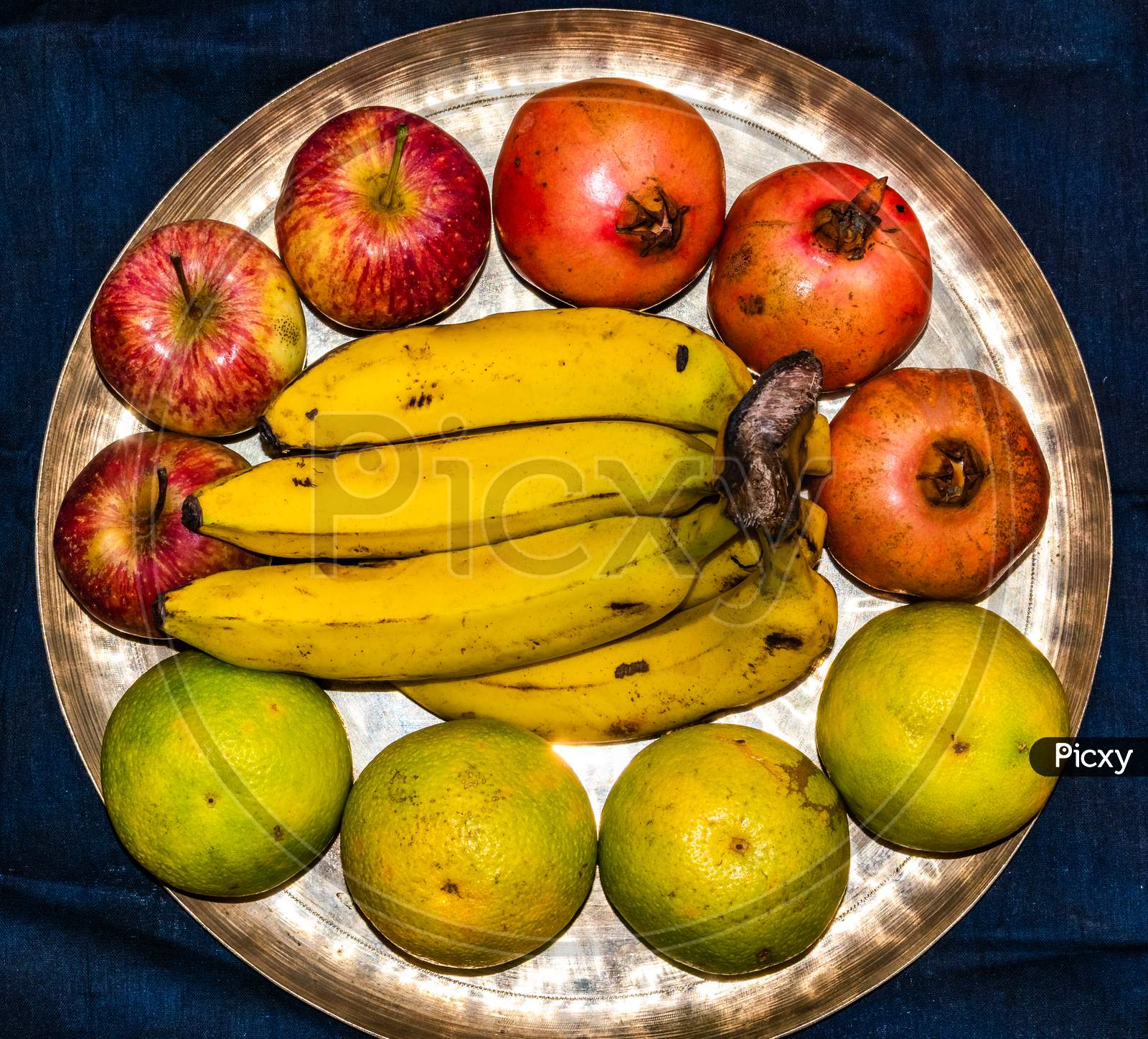 Variety of fresh ripe fruits on brass plate