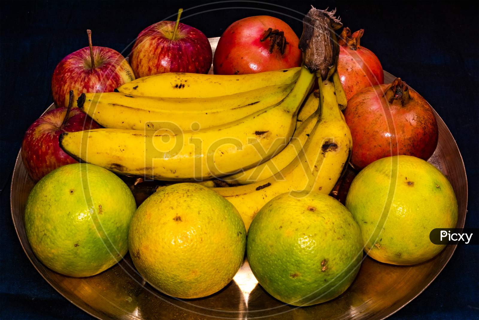 Fresh ripe mixed fruits served on brass plate