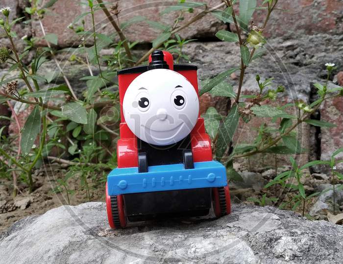 Toy train on a small rock