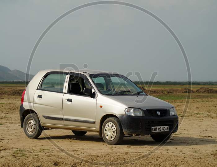Sikar, Rajasthan, India - July 2020: A Maruti alto is standing lonely in empty field on sunny days