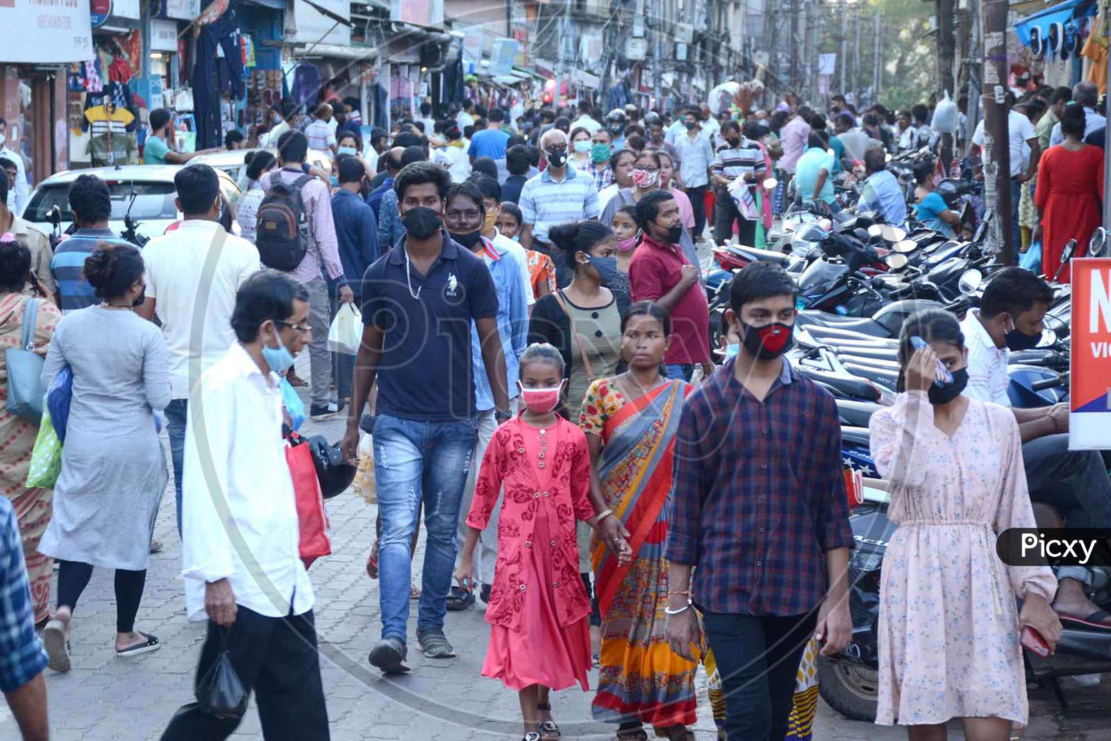 Image of Shoppers croud wearing mask for shopping, at Fancy Bazar ahead ...