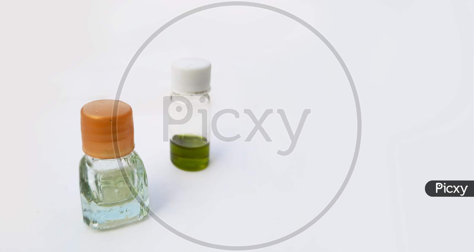 Two Small Perfume Or Attar Bottles Isolated In White Background With Selective Focus