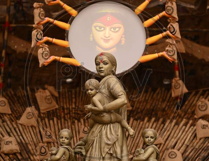 Maa Durga idol as migrant worker displayed for Durga Puja festival at "Behala Barisha club" in Kolkata, West Bengal.