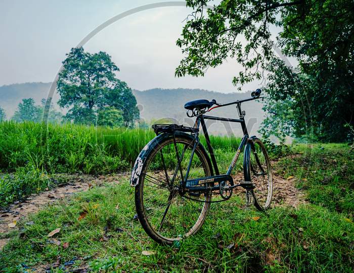 Bicycle in the field waiting for someone to ride it