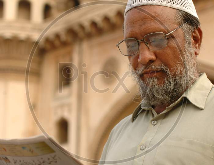 Man Reading Newspaper At Charminar