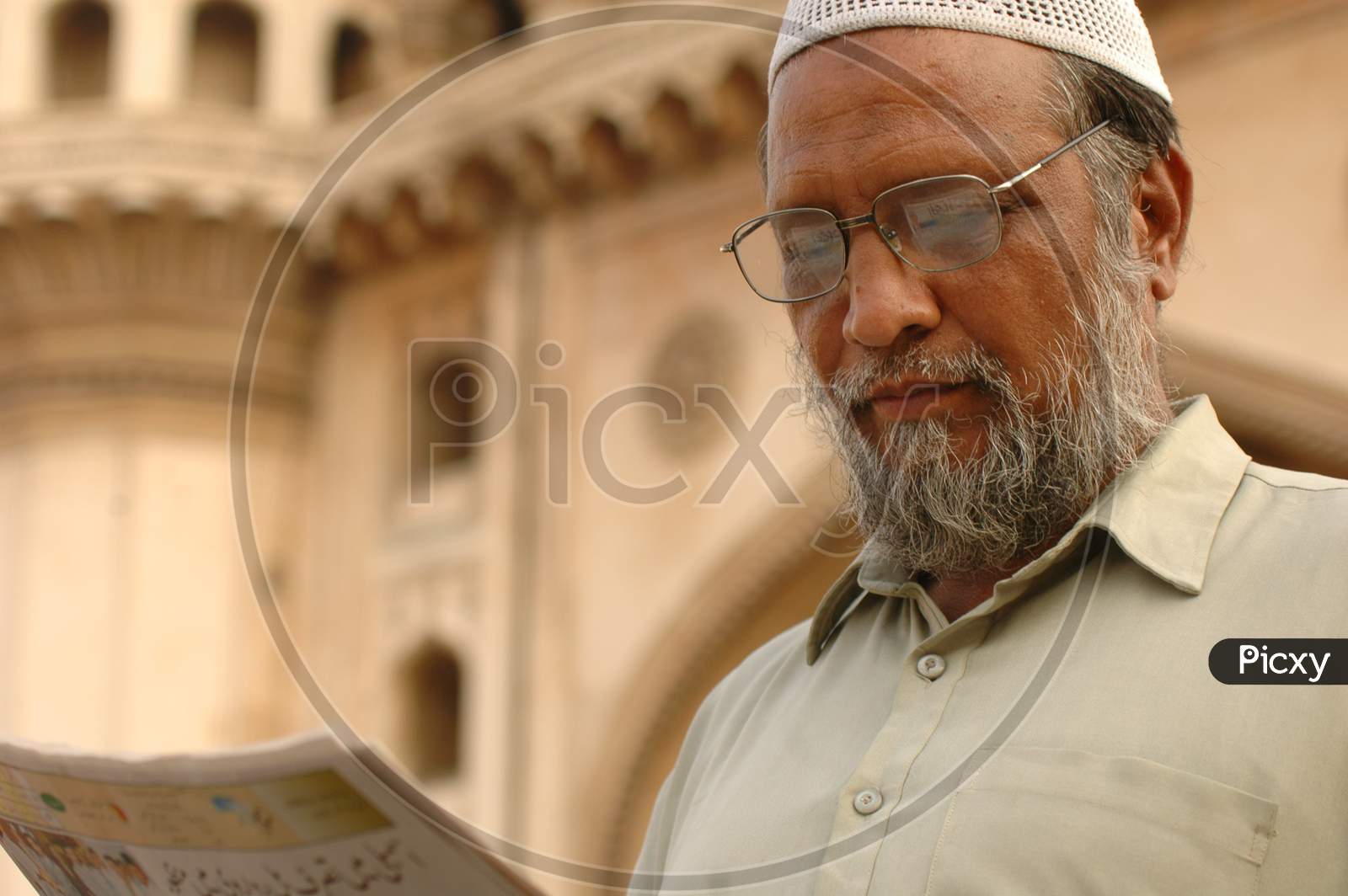 Man Reading Newspaper At Charminar
