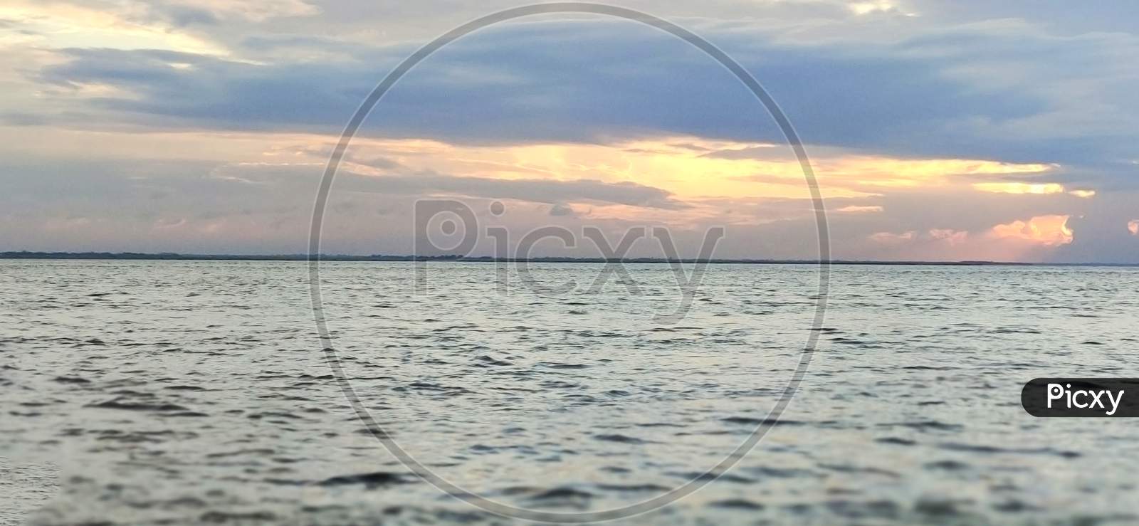 Background Of Colorful Sky On Water Concept: Dramatic Sunset With Twilight Color Sky And Clouds