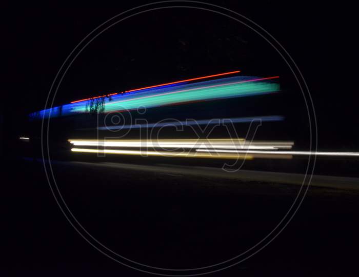 Light trail of a bus on a dark night
