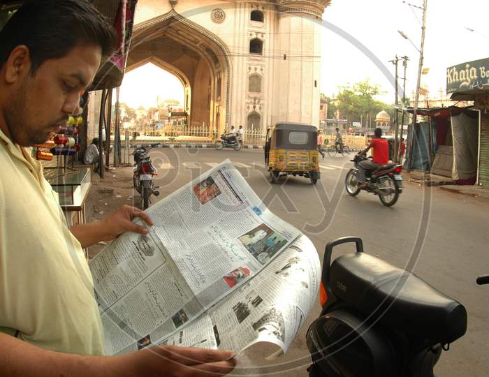 Man Reading Newspaper Near Charminar-Hyderabad