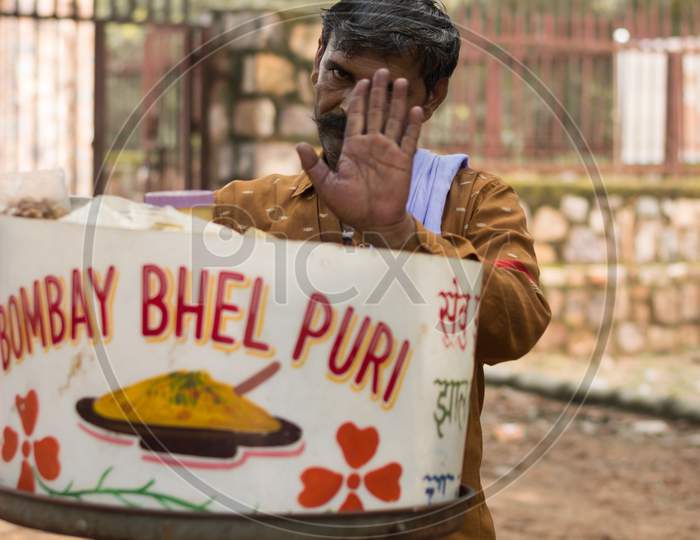 Shy vendor selling bhelpuri on street