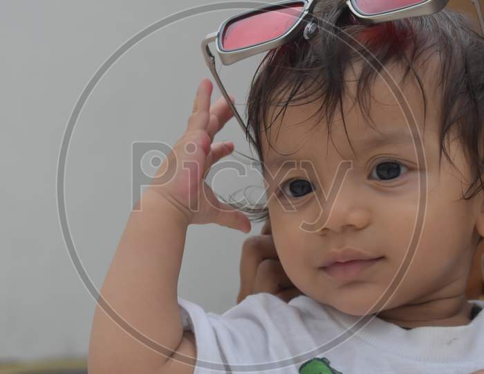 red sunglasses on head of little boy