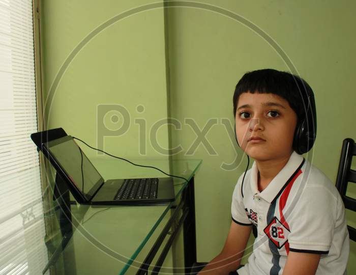 Indian kid having school online. Learning online. Study online. School after Corona outbreak. Technology made life easy to manage school even in corona outbreak
