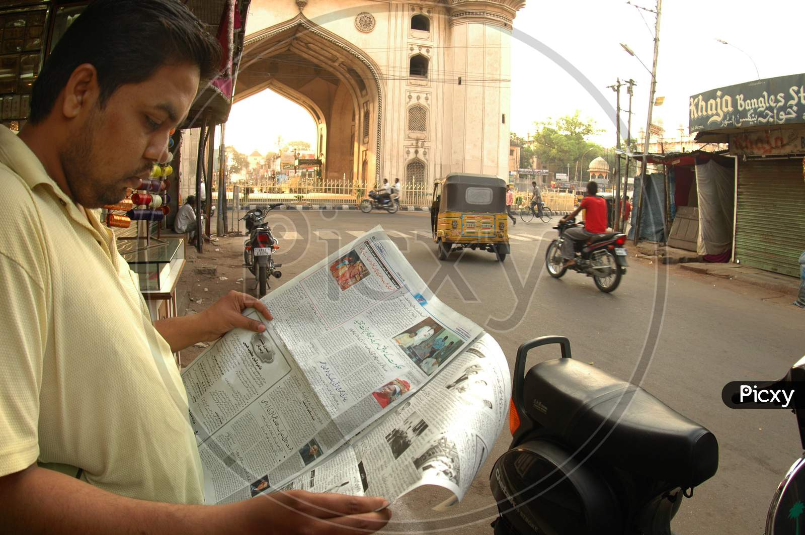 Man Reading Newspaper Near Charminar-Hyderabad