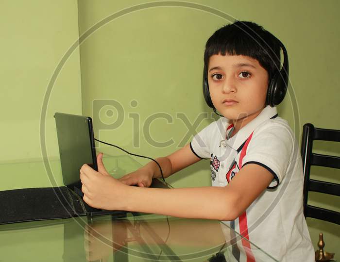 Indian kid having school online. Learning online. Study online. School after Corona outbreak. Technology made life easy to manage school even in corona outbreak