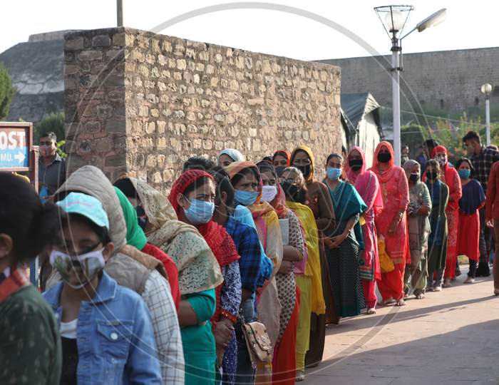 Devotees stand in a queue to pray at a Kali temple during the ongoing Navratri festival, in Jammu 0n 20 october,2020.