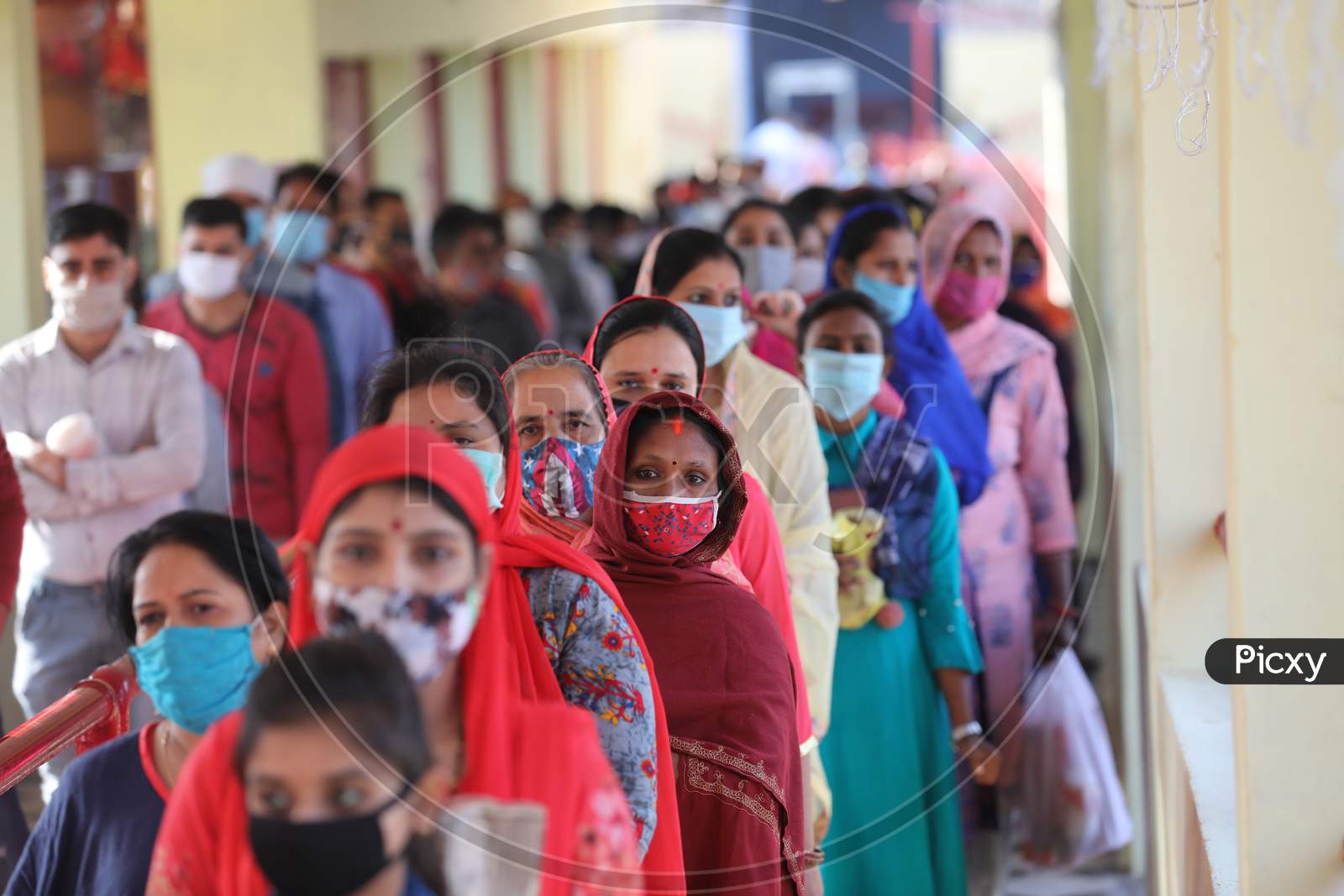 Devotees stand in a queue to pray at a Kali temple during the ongoing Navratri festival, in Jammu 0n 20 october,2020.