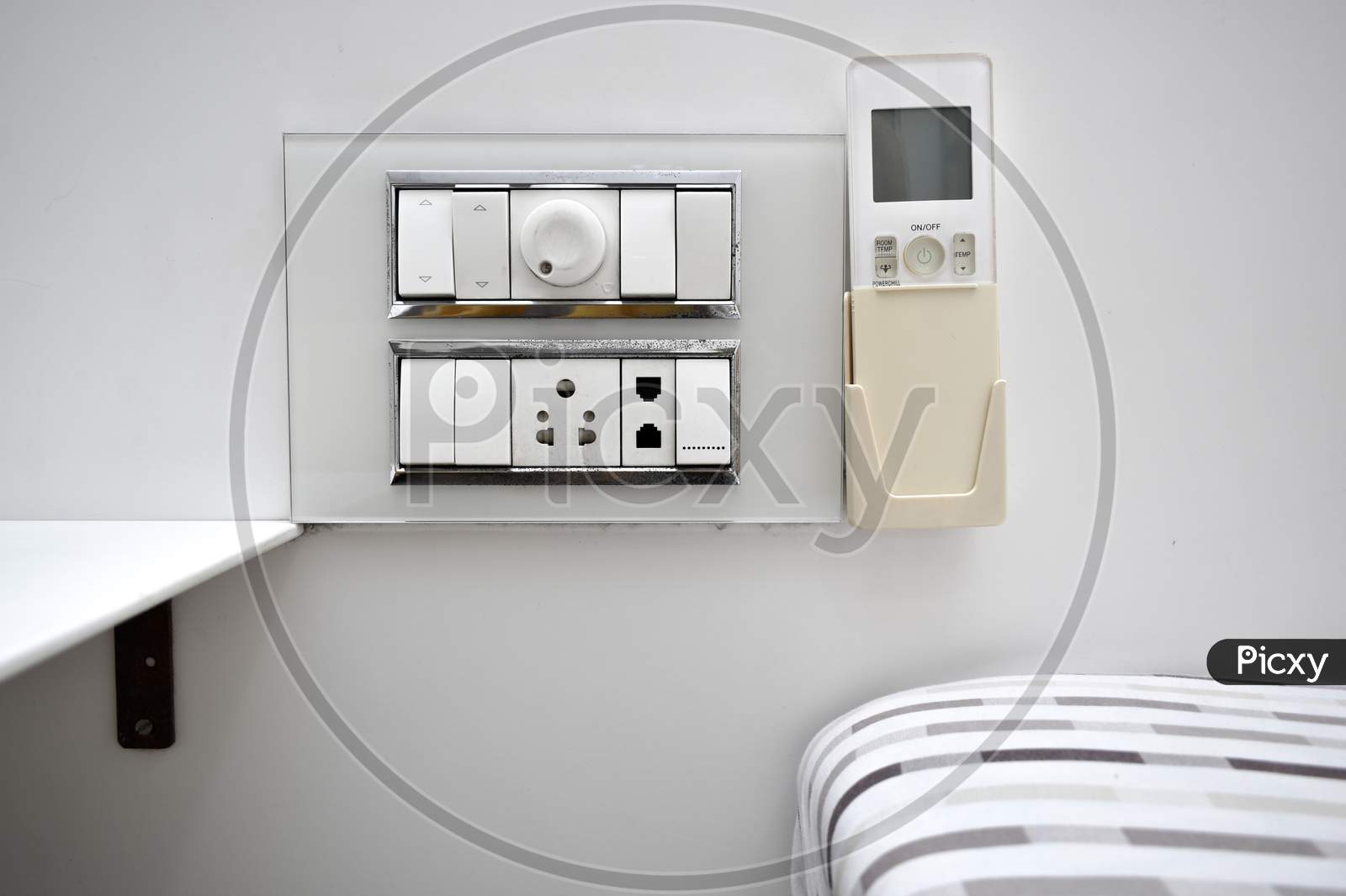 Designer And Unique Switchboard Socket With Regulator And Telephone Pin And Ac Remote Handler On Side Of The Bed