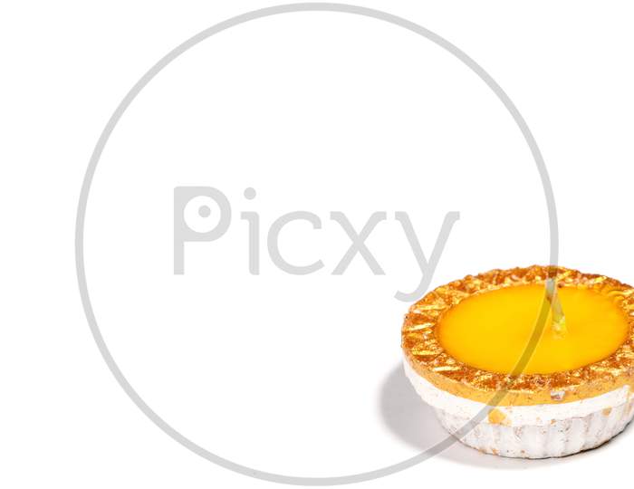 Close-Up Of A Yellow Candle On White Background