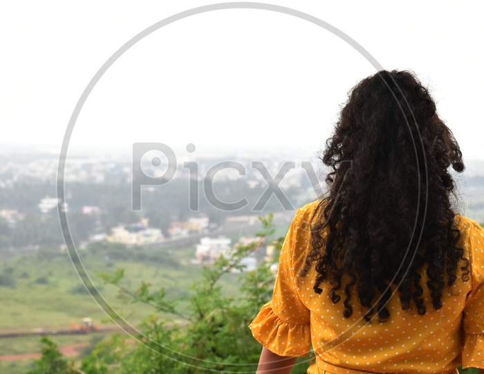 Girl at top balcony viewing outdoor
