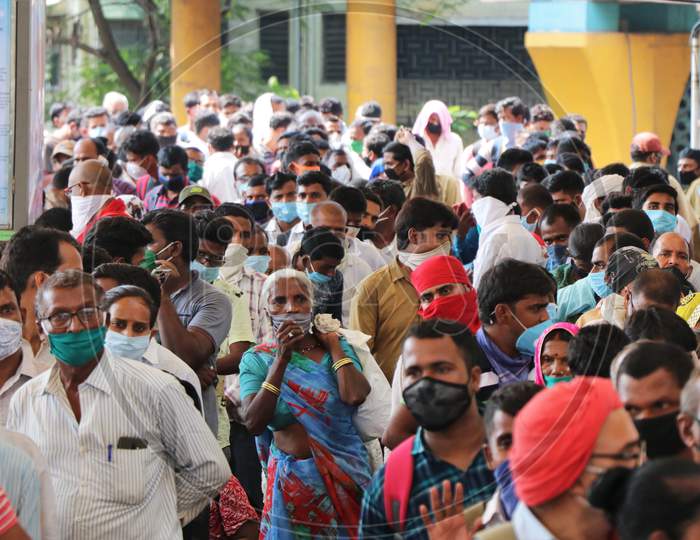 Migrants who returned from their hometown, wait to be tested for the coronavirus disease (COVID-19) during a rapid antigen testing campaign at a railway station, in Mumbai, India, October, 2020.