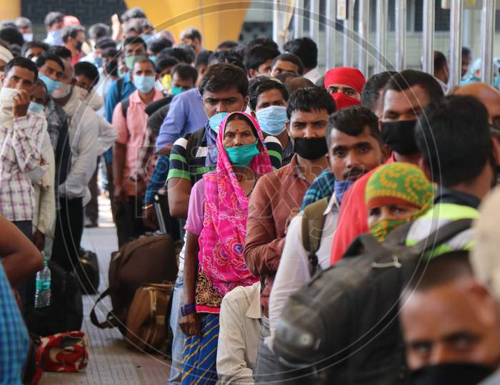 Migrants who returned from their hometown, wait to be tested for the coronavirus disease (COVID-19) during a rapid antigen testing campaign at a railway station, in Mumbai, India, October, 2020.