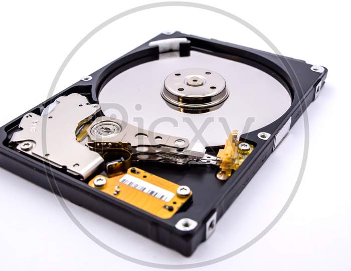 Internal parts of a hard disk isolated on a white background. Close up of Hard disk drive inside view.