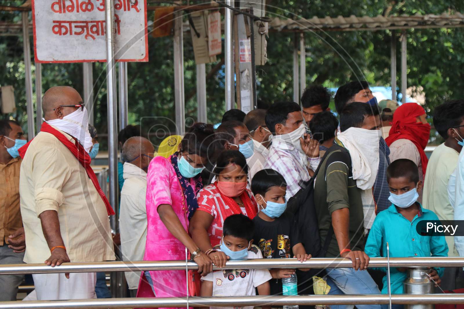 Migrants who returned from their hometown, wait to be tested for the coronavirus disease (COVID-19) during a rapid antigen testing campaign at a railway station, in Mumbai, India, October, 2020.